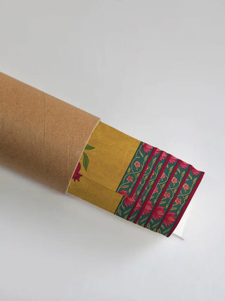 Premium protective shipping tube showing the rolled Royal Bagh print and its floral border detail.