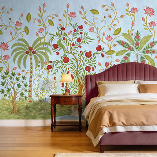 The Royal Bagh blue mural styled in a luxury bedroom behind a plum-colored velvet headboard.
