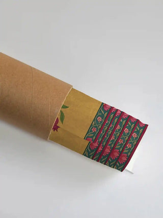 Royal Bagh wall art in marigold gold in its rolled packaging, slipped into a kraft shipping tube for safe delivery.