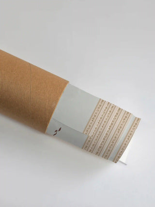 Premium protective shipping tube showing the rolled Royal Enclave print with its delicate floral border.