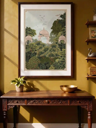 Framed Royal Enclave wall art with peacock and garden pavilions hanging above a carved wooden console in a mustard yellow hallway