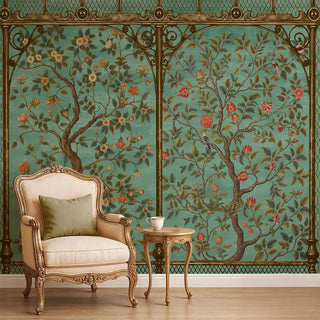 A teal Chinoiserie wallpaper featuring ornate tree branches with blossoms and green foliage, framed by intricate golden borders, styled with a vintage armchair.