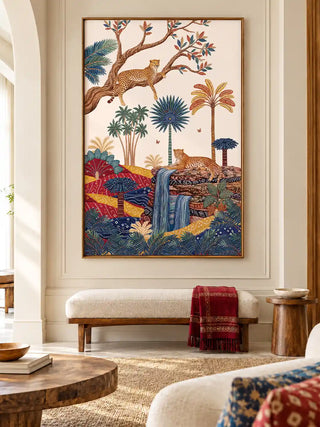 The Royal Jungle Safari wall art, portrait orientation, framed and hung above a cream bench with a red bandhani throw, beside a round side table.