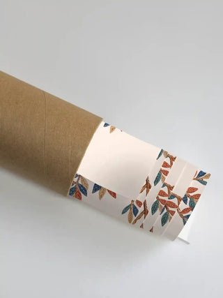 A rolled print of The Royal Jungle Safari wall art showing a detail of the leaf-and-branch border pattern in rust, teal and gold on an ivory ground.