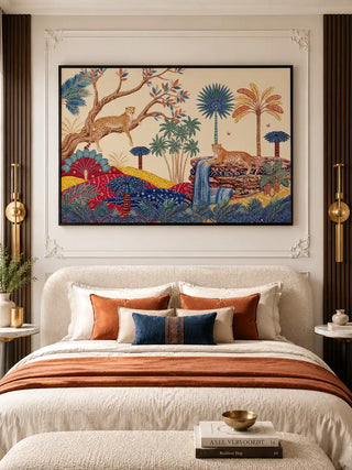 The Royal Jungle Safari wall art in a black float frame above a white upholstered bed with terracotta, navy and ivory cushions, gold cylindrical wall sconces, and dark walnut slatted panel walls in a luxury bedroom
