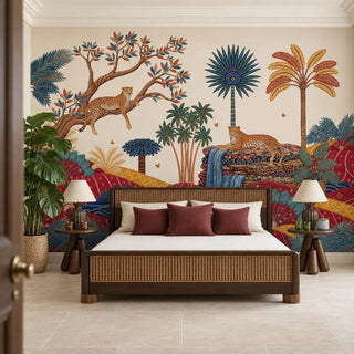 Royal Jungle Safari wallpaper behind a dark wood bed with a woven cane headboard, cream bedding and crimson cushions, flanked by round side tables and cream lamps.