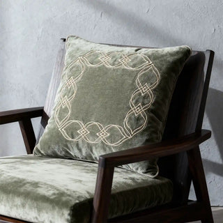 Close-up detail showing the high-quality beige embroidery stitching on the soft sage green velvet fabric of the Ruhana cushion.