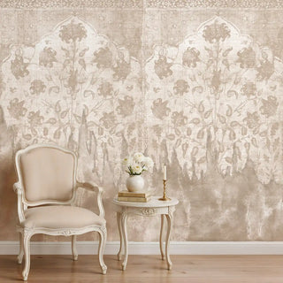 The Kaleen customized beige wallpaper providing a sophisticated backdrop in a cozy reading corner with a classic armchair.
