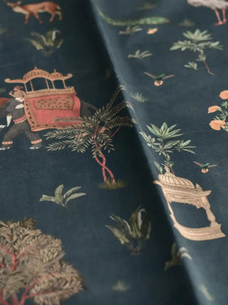 A draped view of the Sair Blue midnight-blue fabric showing the soft textile texture and rhythmic heritage pattern of elephants and trees.