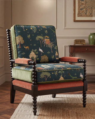 A luxury armchair upholstered in Sair Blue teal heritage velvet with terracotta and sage green accents.
