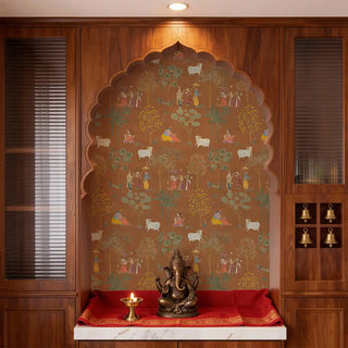 A luxury pooja room featuring Sangam wallpaper with hand-painted Radha Krishna narratives on a warm rust-colored background view-poojaroom