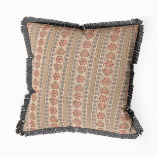 A Sarangi Fringes cushion cover featuring vertical, patterned stripes in pink, beige, and gray, with a distinctive dark fringe.