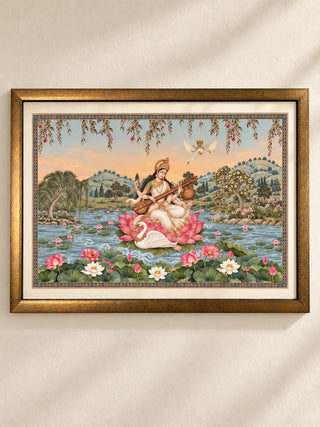 Saraswati Maa framed wall art: the goddess playing the veena on a pink lotus beside a swan, landscape wooden frame with ivory mount