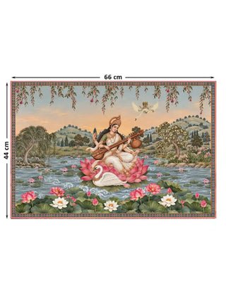 The Saraswati Maa wall art, small size 44 by 66 centimetres, showing Saraswati seated on a lotus playing the veena beside a swan, amid a lotus pond and pastoral landscape.