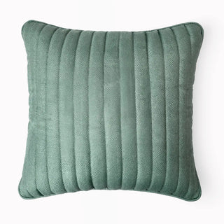 Single Sea Mist Cushion displayed on a dark grey armchair for a dramatic contrast.