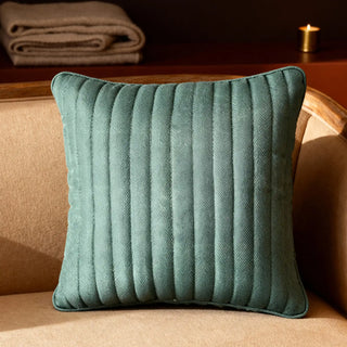 Full studio view of the Sea Mist Cushion with light blue base and navy fringed waves.