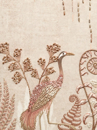 A close-up of The Secret Garden embroidered wall art showing a hand-embroidered crane worked in sequins and beadwork among fern fronds and berry sprays.