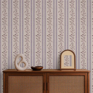 Lavender & beige floral stripe wallpaper styled behind a wooden console with minimal décor accents.