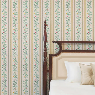 Yellow floral stripe wallpaper behind a wooden bed with neutral bedding, adding a vibrant and classic touch.