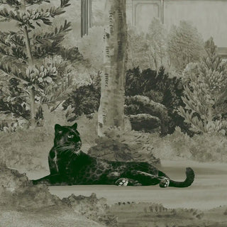 A close-up of the wallpaper showing a black panther resting near tall trees with intricate foliage in soft pastel green tones.