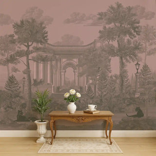 A pink and green vintage-style wallpaper featuring classical arches, tall palm trees, and black panthers, styled behind a wooden console with flowers.