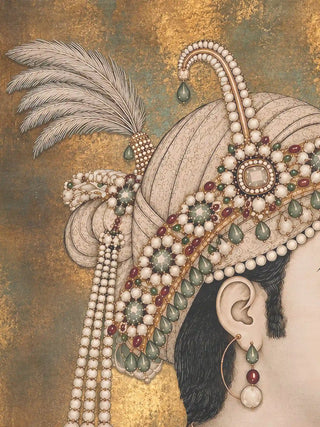 Close up of Shahenshah-e-Riyasat wall art showing the texture of the heron feather plume, emerald drop sarpech and hand-painted pearl strands against gold leaf
