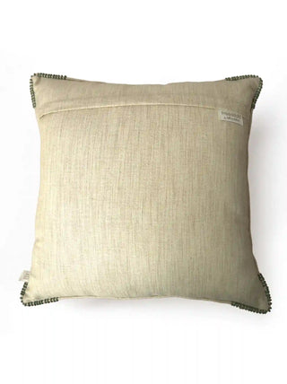 The reverse side view of the Shahzar cushion cover showing the clean beige linen backing, hidden zipper enclosure flap, and brand woven tag.