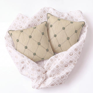Shahzar gift set: two Shahzar cushion covers nestled in Prasanaakshi gift wrap
