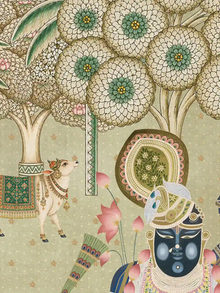 A detail of the Shrinathji Madhuban wall art showing a tree with large round blossom clusters, a cow in an embroidered green blanket with a jewelled necklace, and the central figure’s halo and feathered turban.