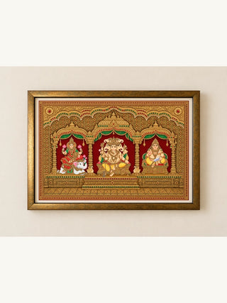 Shriyam framed wall art: Ganesha, Lakshmi and Kuber under golden arches in Tanjore style on red, landscape wooden frame with ivory mount
