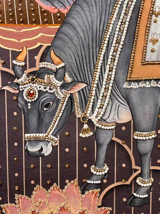 A detailed macro close-up of the Shyam Sundar embroidered wall art highlighting a grey cow dressed in pearl and bead harnesses above lotus petals.