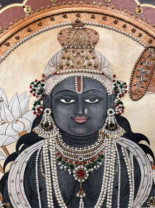 A detailed macro close-up of the Shyam Sundar embroidered wall art highlighting Krishna’s face with pearl strands, jewelled earrings and a beaded crown.