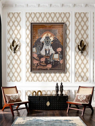 The Shyam Sundar hand embroidered wall art framed in a modern-style living room above a wooden chest paired with ikkat wallpaper and embroidered cushions