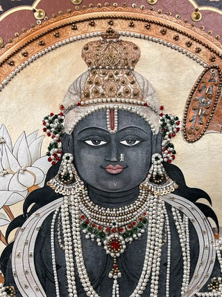 Close-up detail of Lord Krishna's face on the Shyam Sundar art featuring intricate pearl and bead headgear embroidery.