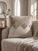 Beige Sierra Lattice cushion ocver with mountain design on a beige sofa in a cozy living room.