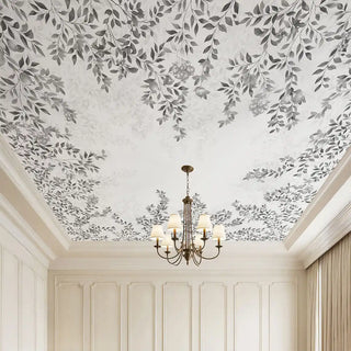 A luxury grand room featuring the Silent Orchard light charcoal ceiling mural styled with a classic tiered chandelier and white wall panels.
