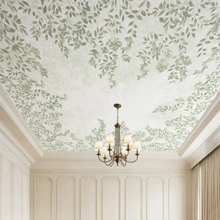 A luxury grand room featuring the Silent Orchard light sage ceiling mural styled with a classic tiered chandelier and white wainscoting.