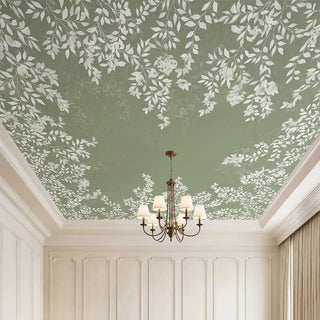 A luxury grand room featuring the Silent Orchard deep sage ceiling mural styled with a classic bronze chandelier.