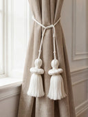 Silkstone white tassel tieback with beaded crowns on beige linen curtain