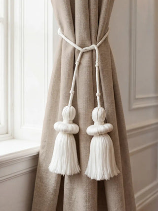 Silkstone white tassel tieback with beaded crowns on beige linen curtain