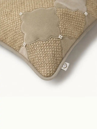 A high-resolution macro shot of the tight grey satin-stitch embroidery bordering the textured basket-weave panel.