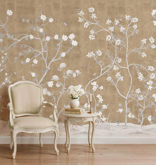 Sitara Chinoiserie wallpaper featuring white star-shaped flowers on a beige textured background behind a cream armchair.