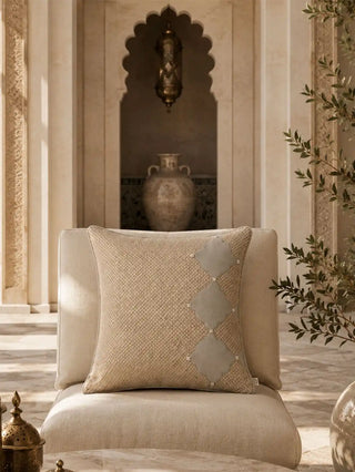 The Sirocco Moroccan arch cushion cover styled on a rich chocolate brown velvet sofa panel next to a modern tripod floor lamp.