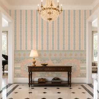 The Songbird Garden Stripe wallpaper on the lower wall of a marble-floored foyer, styled with a dark wood console table and brass chandelier. view-foyer
