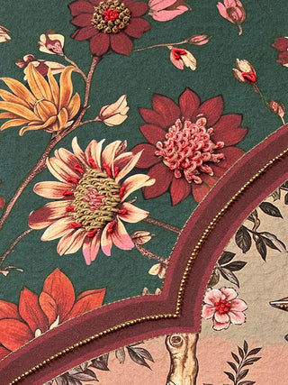 Detailed view of the rich forest green background and textured floral motifs in the Sorena wall art design.