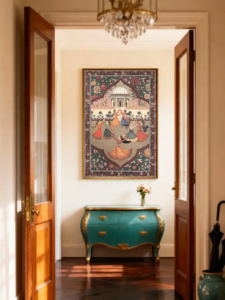 Luxury Sorena wall art featuring Sufi dancers displayed in a bright foyer above a turquoise and gold ornate console table.