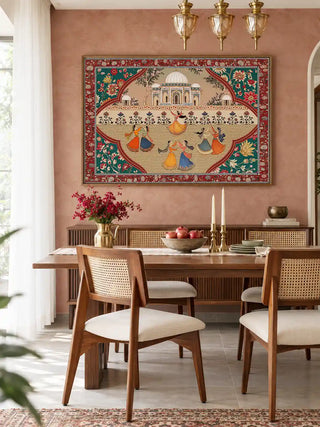 The Sorena wall art in a wood frame, displayed above a wooden sideboard in a pink dining room with brass pendant lights.