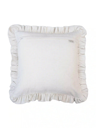 Back view of the Spellbound ruffle cushion cover in dark green, showing the concealed zip closure, brand label and ivory ruffle border.
