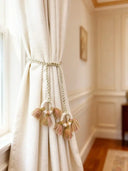 Springhaven macrame ring-suspended rose and sage-green tassel tieback on cream linen