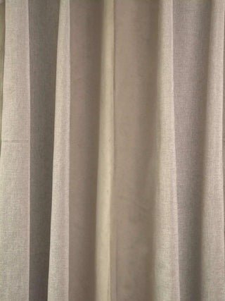 A high-resolution close-up of the premium taupe linen-blend fabric weave and soft drapery folds of the Storah curtain.